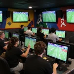 Fans engaged in sports betting at the 7M lounge, with excitement and live game footage.